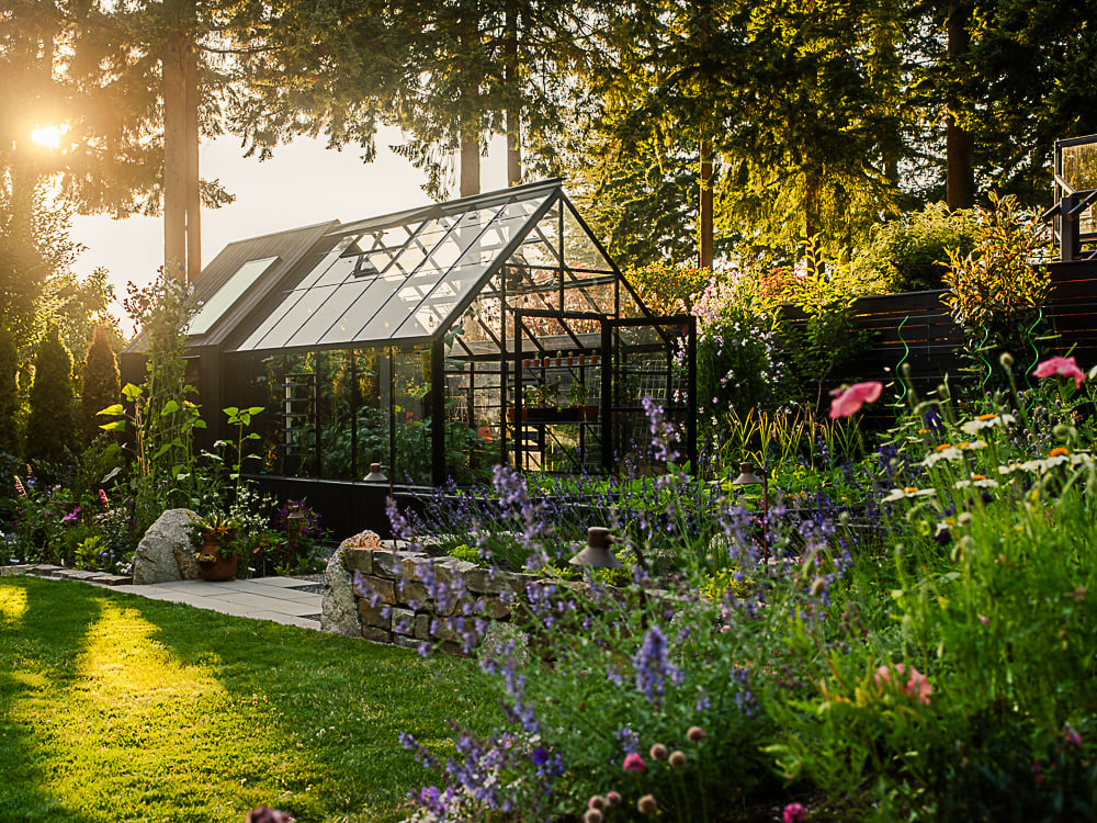 building attached greenhouse surrounded by lavender with a stone walkway leading to the front door
