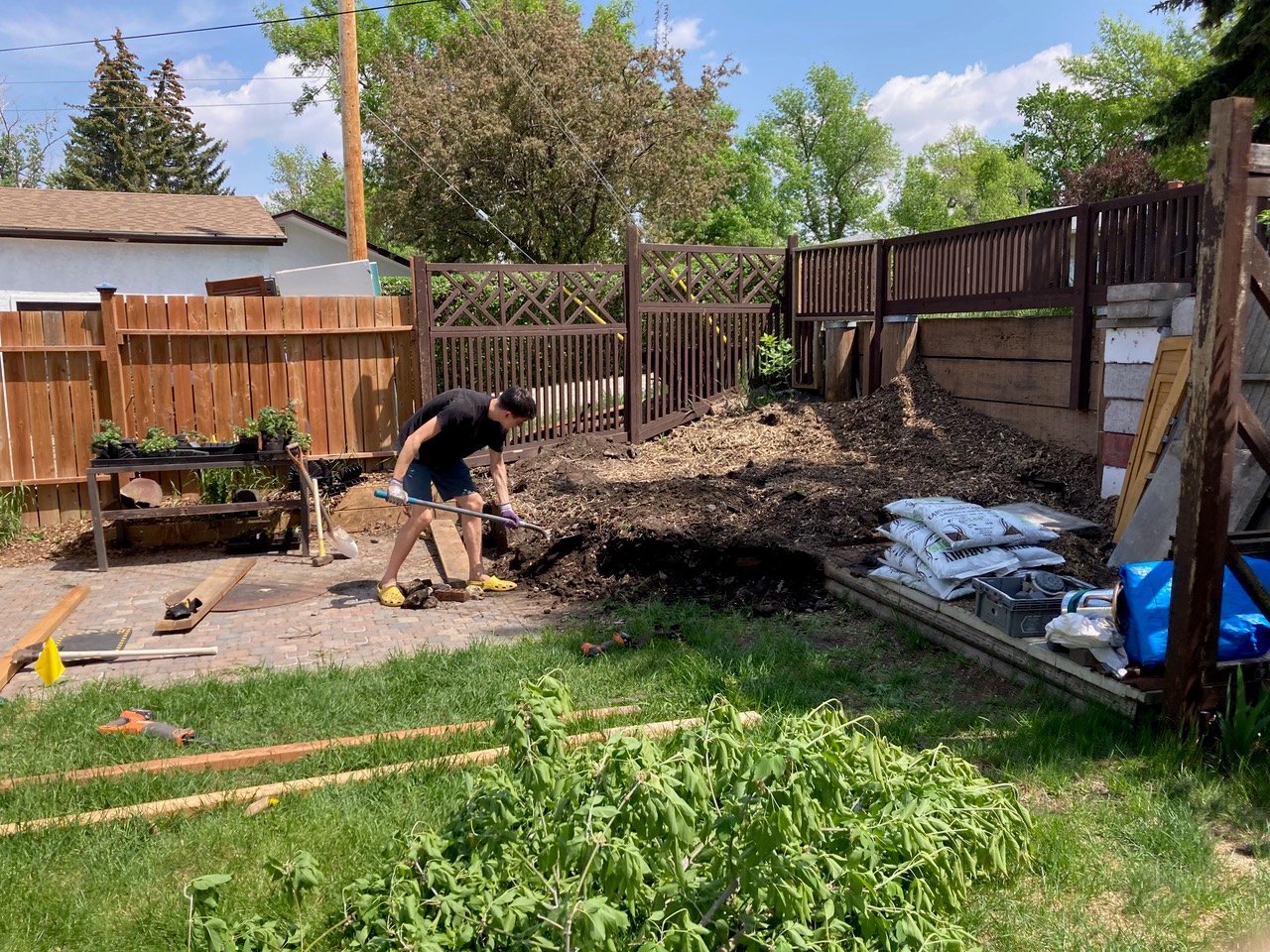 boy digging greenhouse foundation